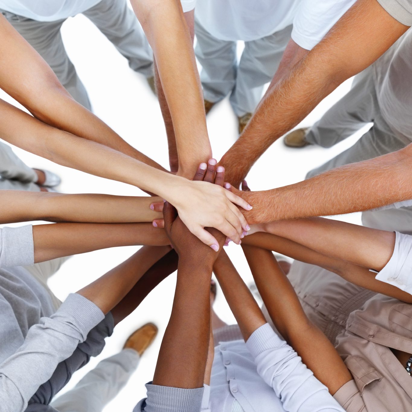 Many hands coming together in a gesture of teamwork and collaboration.